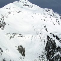 A large peak with broad, steep open faces and overlapping paths.