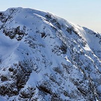 A very steep, rocky mountain face with cliffs.